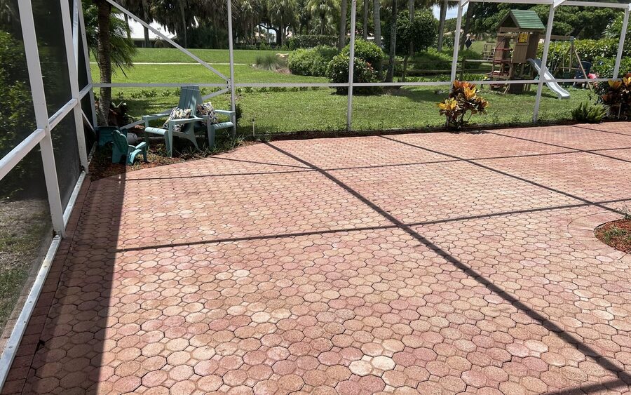 Screened enclosure after cleaning looking out through clear screen panels to open lawn