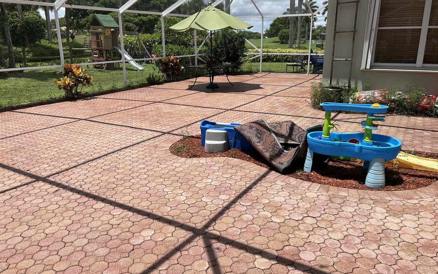 Screened lanai paver deck after cleaning looking back toward the house
