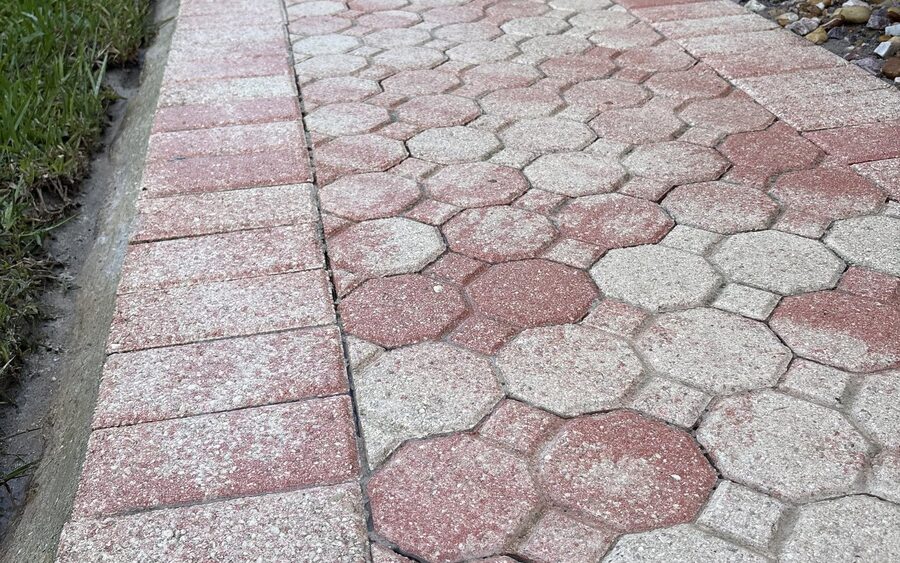 Paver walkway after cleaning with the border course colour restored