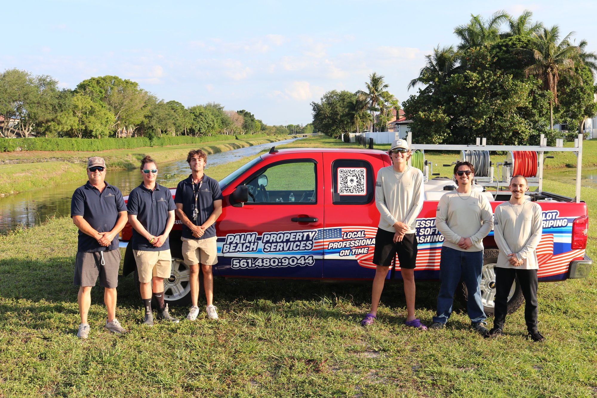 Palm Beach Property Services team with branded signage