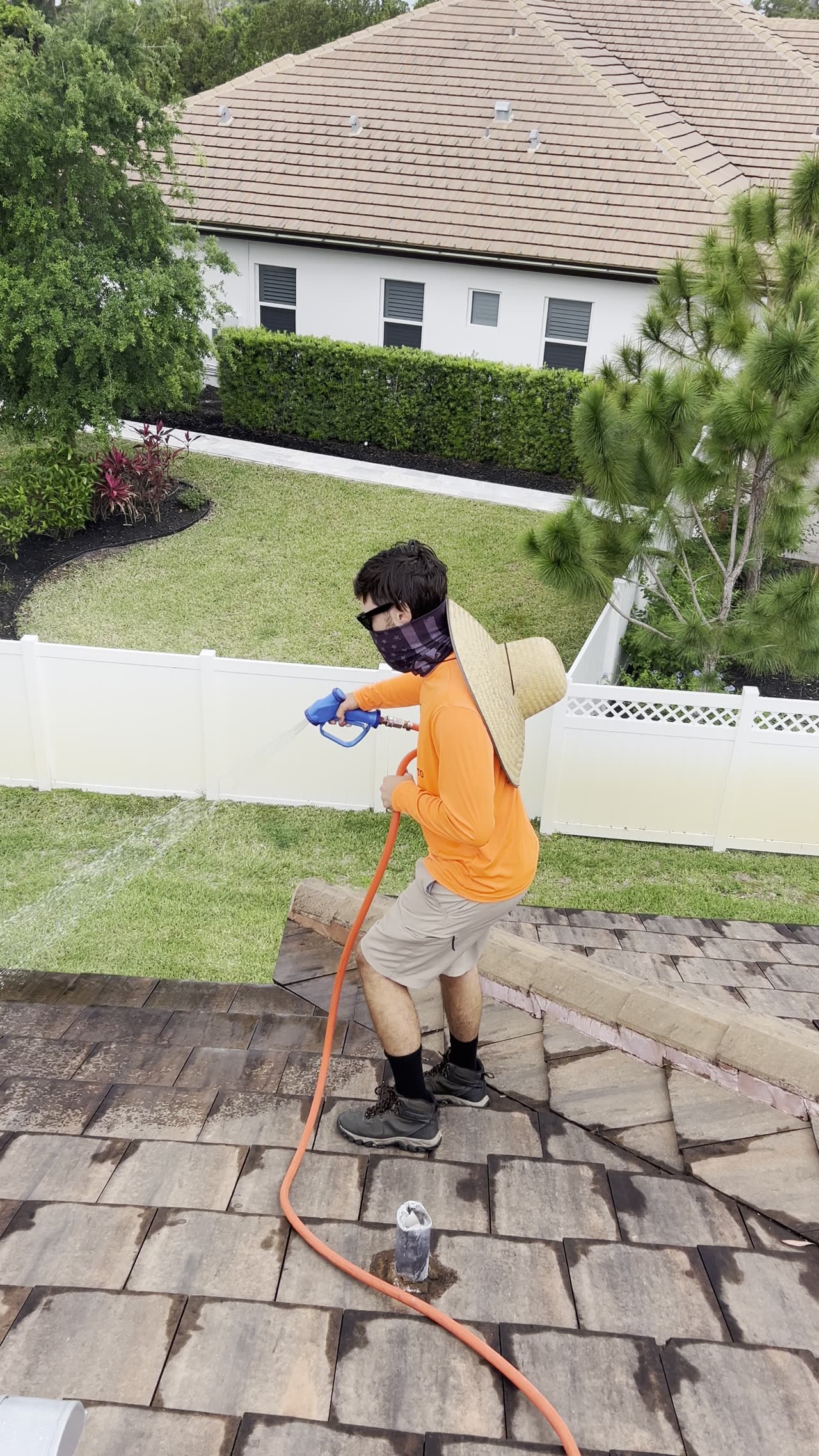 On-site soft wash treatment being applied to exterior surface
